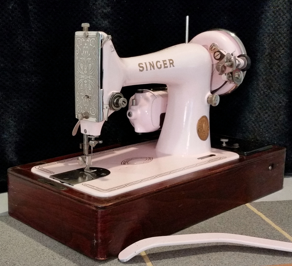 Beautiful pink Singer model 99 vintage sewing machine in bentwood case